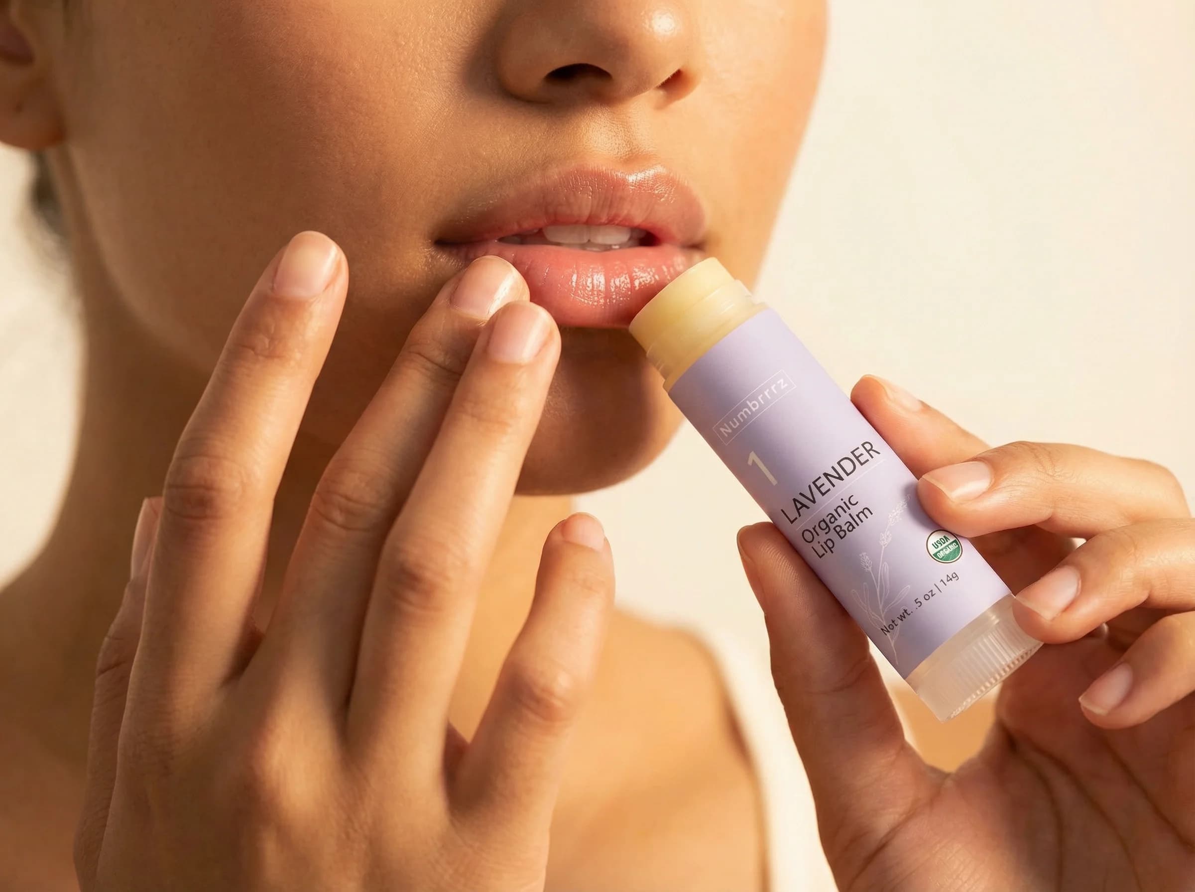 Numbrrrz lavender organic lip balm being applied